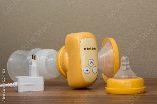 breast pump yellow on a wooden table