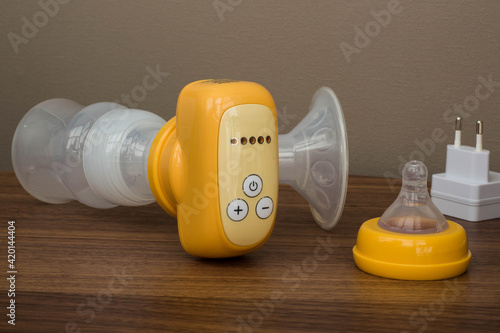 breast pump yellow on a wooden table