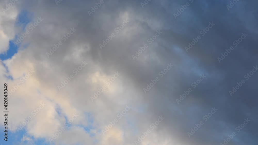 Moving clouds on a blue sky. Evening clouds on a blue sky. Moving clouds on a blue sky. Evening clouds on a blue sky.