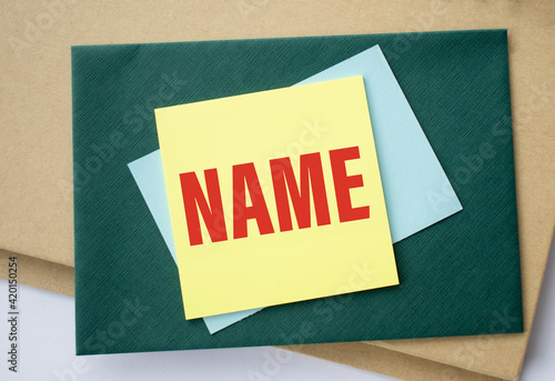 paper with word Name pasted on green paper