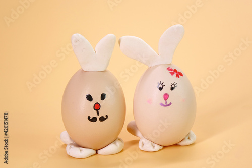 Funny Bunny Easter eggs isolated on beige color background © Cheattha
