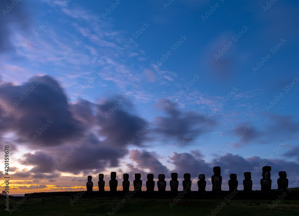 Silhouette of Moai statues at sunrise, Ahu Tongariki, Easter Island (Rapa Nui), Chile.