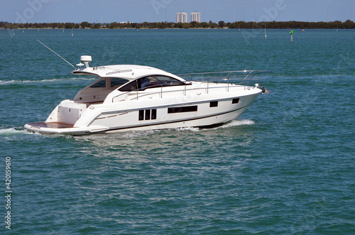 High end white cabin cruiser on the Florida Intra-Coastal Waterway off Miami Beach.