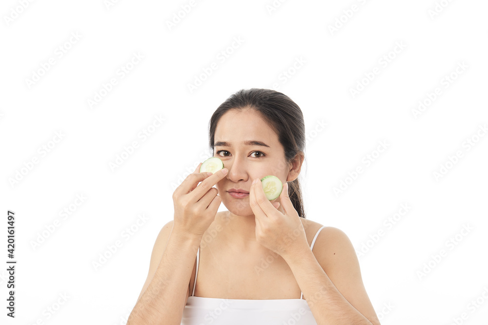 Beautiful young asian woman with cucumber slices