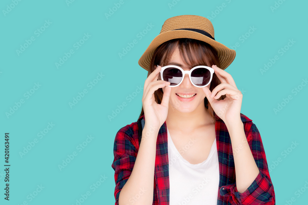 Beautiful portrait young asian woman wear hat and holding sunglasses smiling confident enjoy journey summer trip in vacation isolated on blue background, tourist asia girl cheerful with travel. Beautiful portrait young asian woman wear hat and holding sunglasses smiling confident enjoy journey summer trip in vacation isolated on blue background, tourist asia girl cheerful with travel.