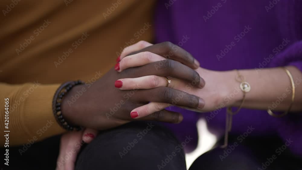 Close-up diversity hands together. Two people hand in hand Close-up diversity hands together. Two people hand in hand