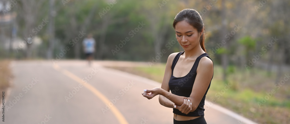 Fitness woman in sportswear resting after running in the park. Fitness woman in sportswear resting after running in the park.