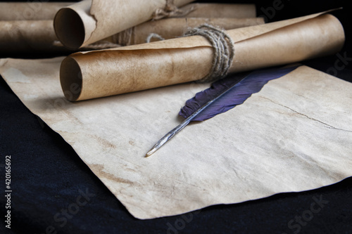Ancient paper scrolls sealed with a seal on an old map. Pen for writing.