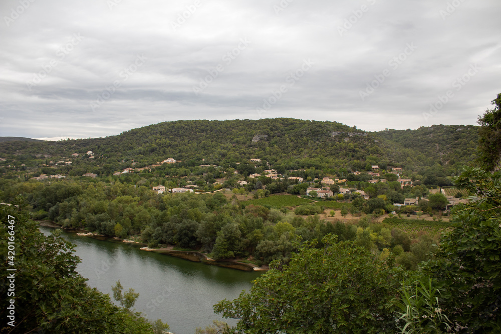 Ardeche river with village in background - France