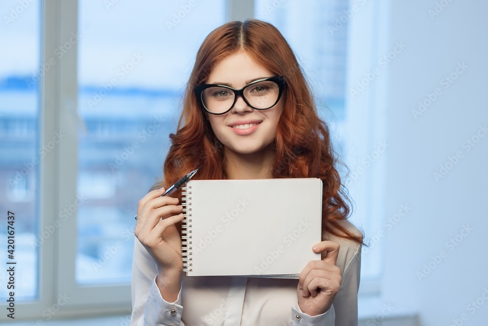 Business woman in white shirt with notebook in hands of office professionals Business woman in white shirt with notebook in hands of office professionals