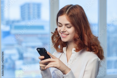 pretty woman in shirt with phone in hand technology professional official