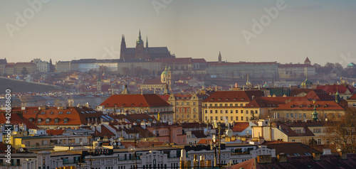 View of Prague Castle and St. Vitus Cathedral and the roofs of buildings in Prague at sunset