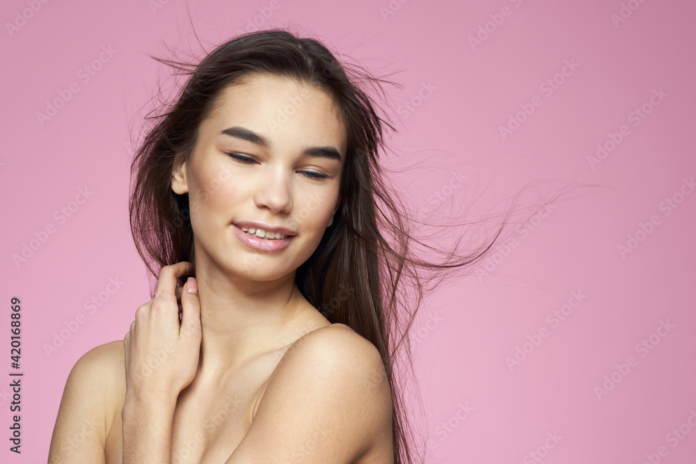 Pretty brunette naked shoulders clear skin pink background Pretty brunette naked shoulders clear skin pink background