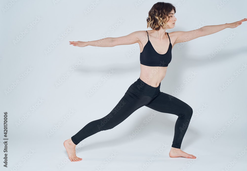 sportive woman doing exercises bending knees yoga asana