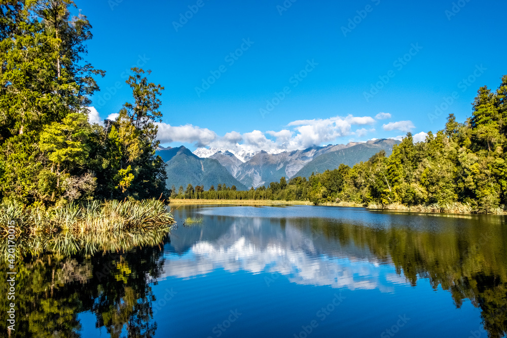 The Southern Alps reflecting in Matheson Lake. South Island, New Zealand. The Southern Alps reflecting in Matheson Lake. South Island, New Zealand.