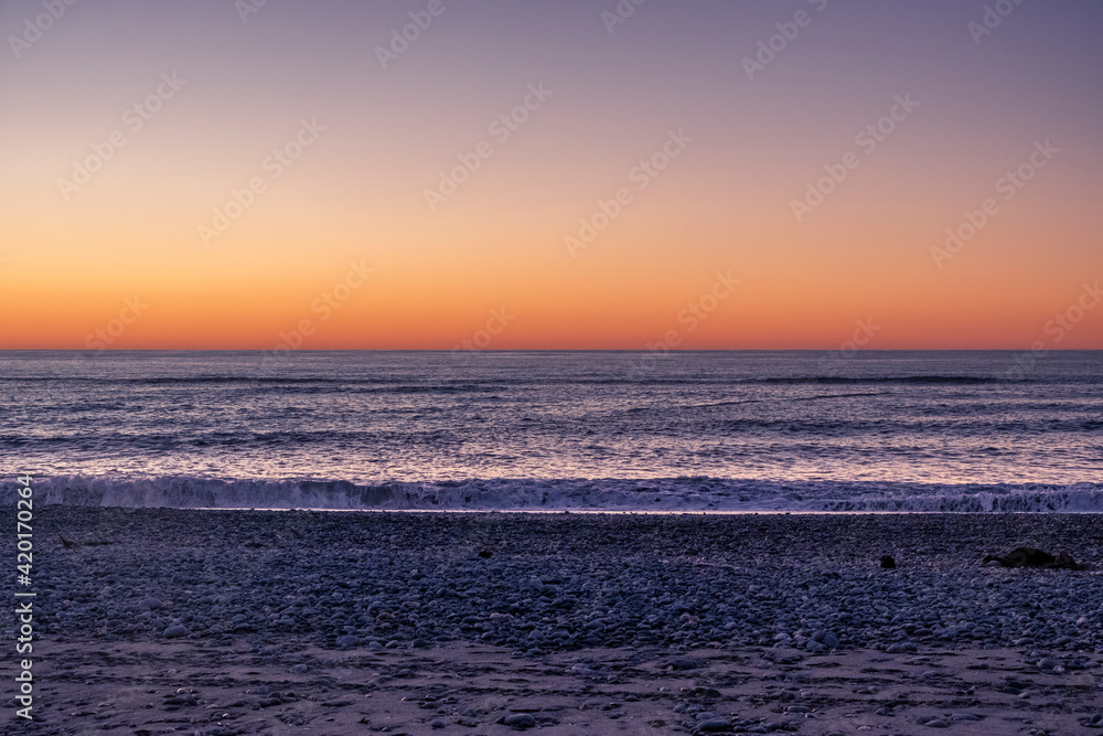Ocean beach at sunset. South Island, New Zealand.