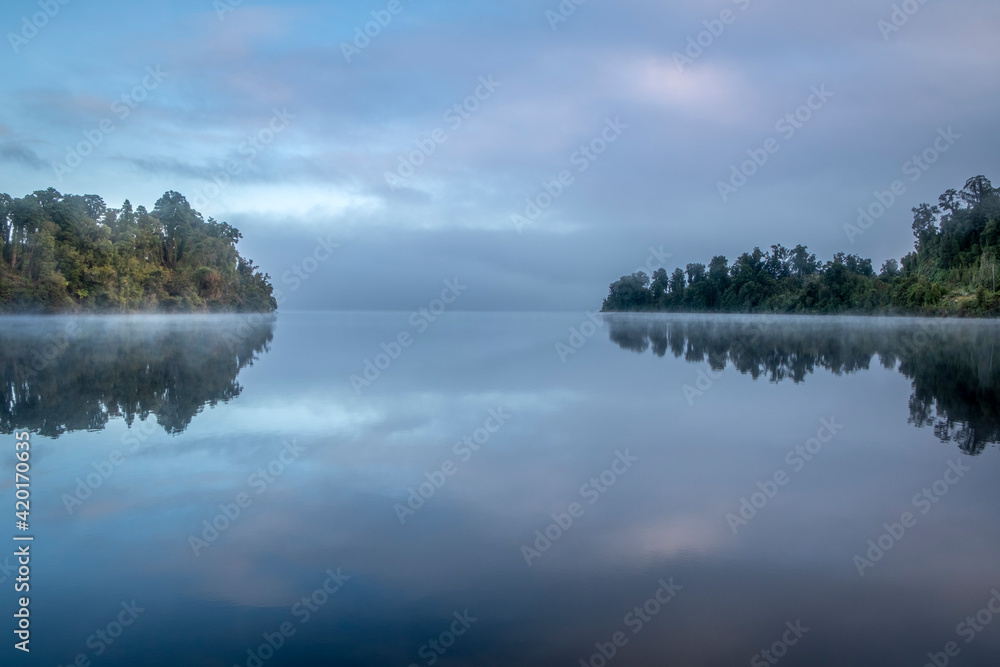 Morning fog over a beautiful lake. South Island, New Zealand.