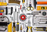 various renovation instruments and hand tools on metallic grey background