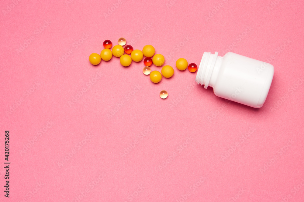 Open jar with pills on pink background coldspace top view Open jar with pills on pink background coldspace top view