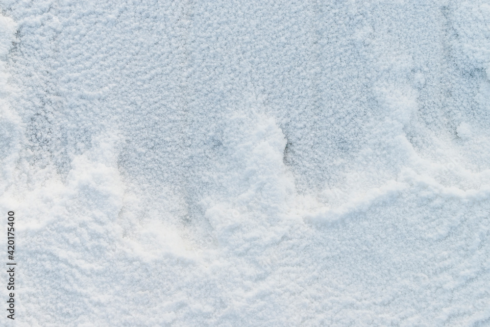 Snowy background. View from top. Snow crystals cover the boards, a figured snowdrift. Concept for Christmas, New Year.