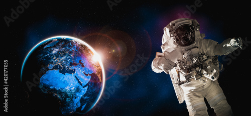 Cuadro en lienzo Astronaut spaceman do spacewalk while working for space station in outer space