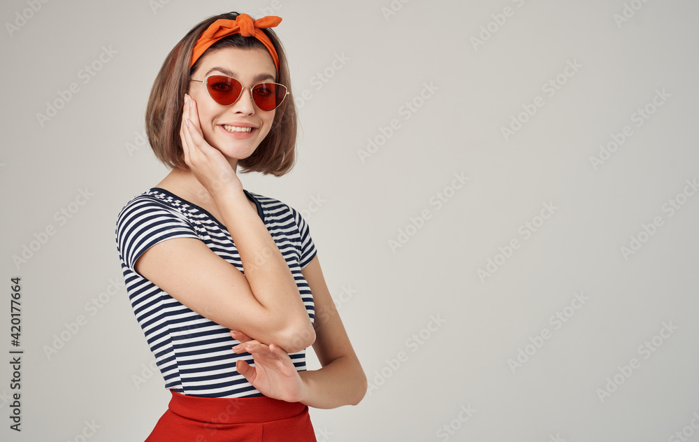 Fototapeta premium cheerful pretty woman with orange headband red skirt fun Studio