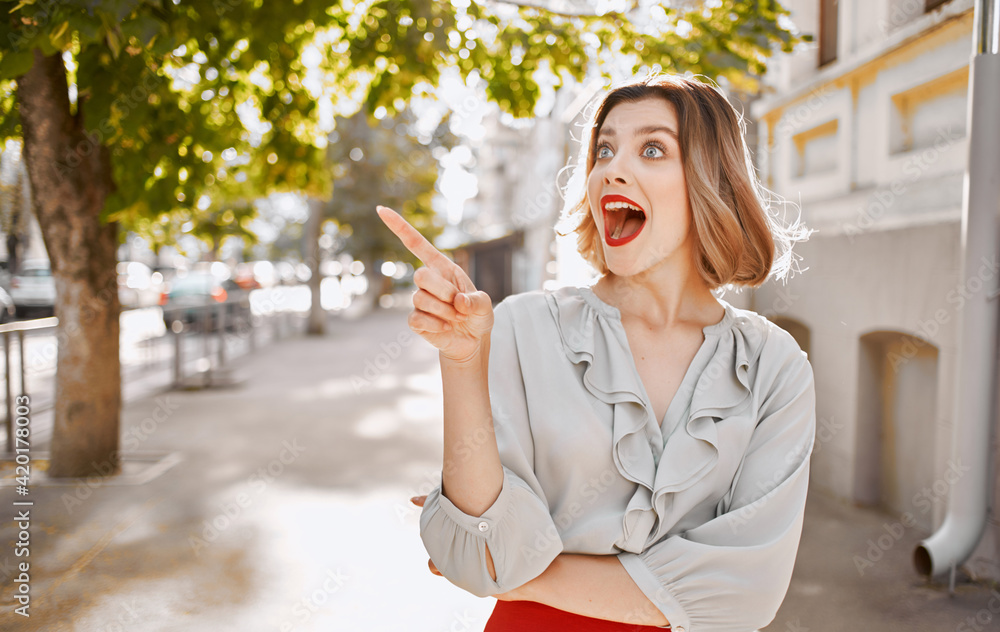 happy blonde girl with bright makeup near building gesturing with hands fashionable clothes style happy blonde girl with bright makeup near building gesturing with hands fashionable clothes style