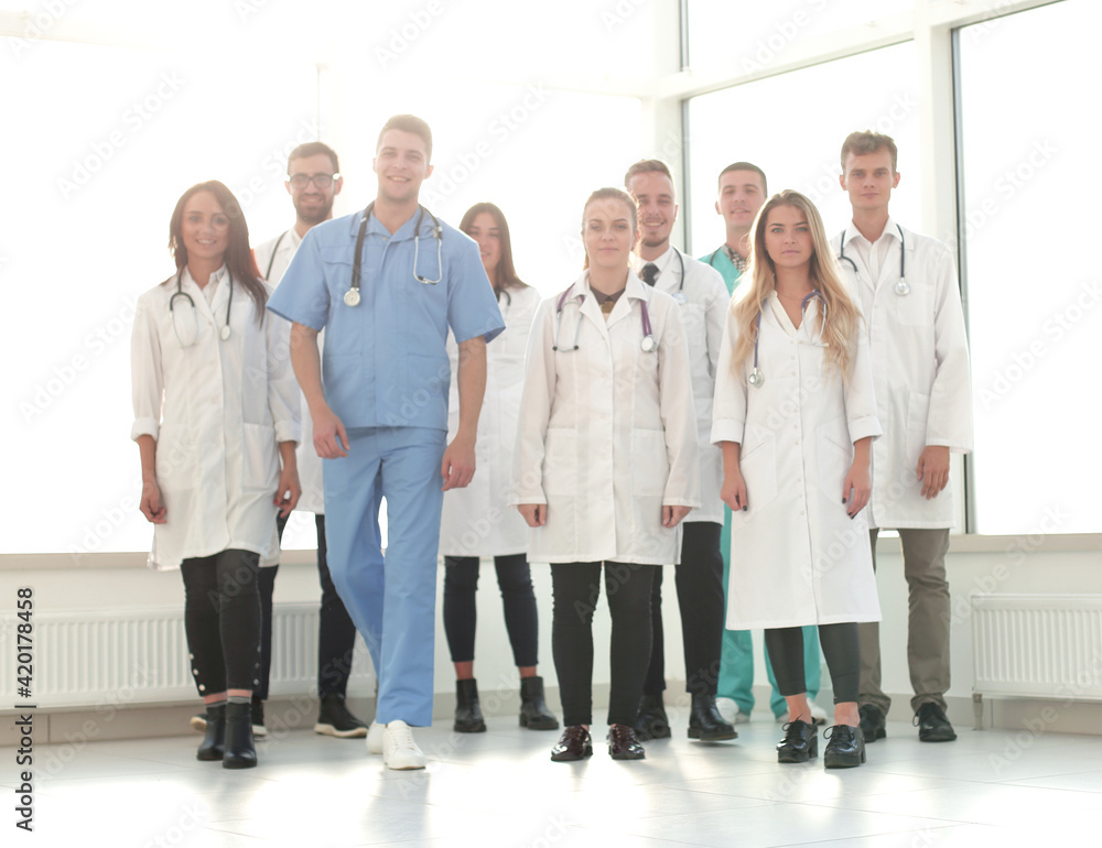 group of confident doctors striding in the hospital corridor group of confident doctors striding in the hospital corridor