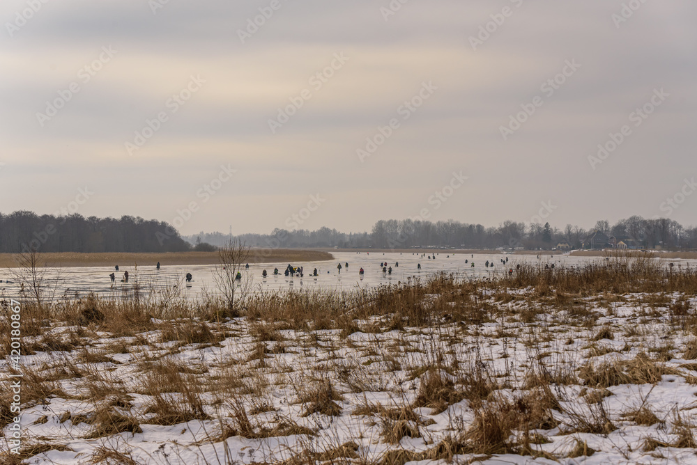 frozen river, bent and icy anglers