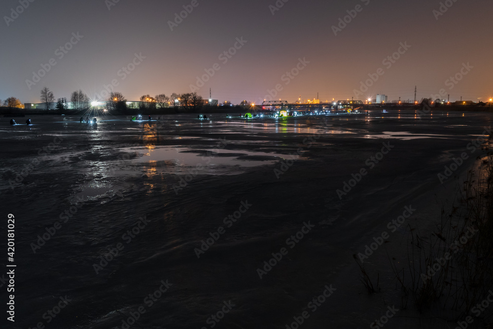Fototapeta premium frozen river, night and ice anglers