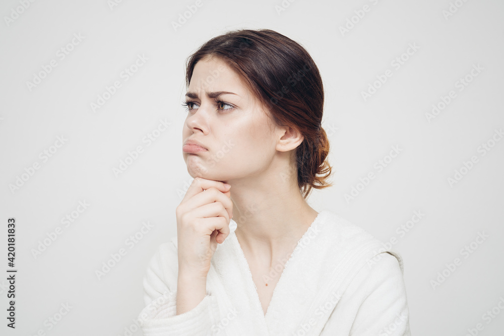 woman in light clothes wipes her face with a soft sponge clean skin cosmetology woman in light clothes wipes her face with a soft sponge clean skin cosmetology