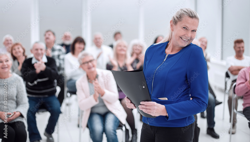 Businesswoman addressing colleagues at office meeting Businesswoman addressing colleagues at office meeting