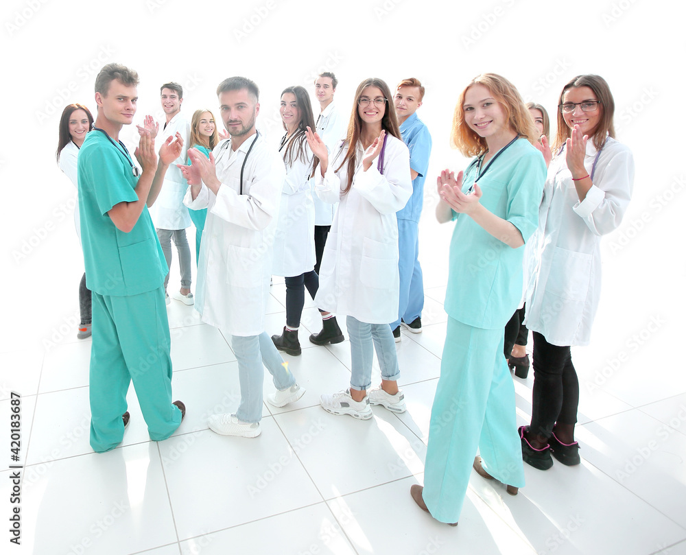 team of diverse doctors applauding their joint success team of diverse doctors applauding their joint success