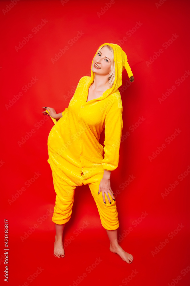 Funny girl in a yellow overalls on a red background. Funny girl in a yellow overalls on a red background.