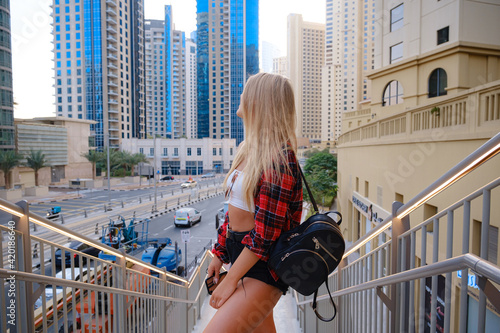 Photography Young blonde travel woman walking on the street outdoors in Dubai city