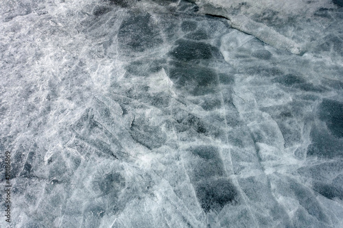 The texture of the surface of ice on a frozen lake. Natural background.