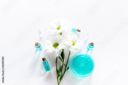 flowers and natural oils on white background
