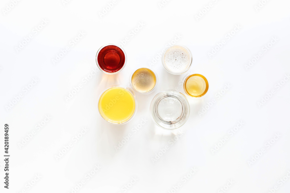 Soft drinks in double-walled glasses on a white top view background Soft drinks in double-walled glasses on a white top view background