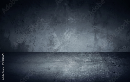 Dark room in beam of light with concrete wall and floor. Texture background image