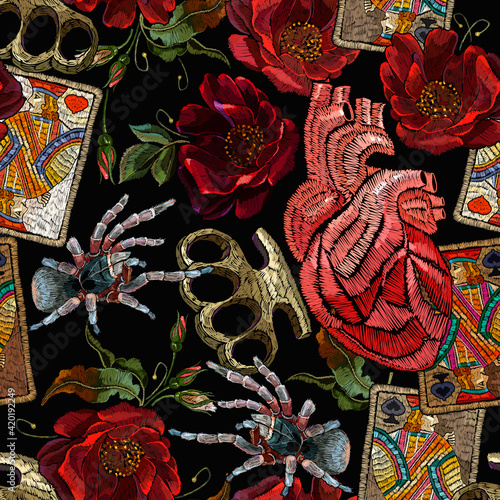 Embroidery playing cards, brass knuckles, spider and red roses flowers. Seamless pattern. Street culture style. Fashion template for design. Dark gothic halloween art