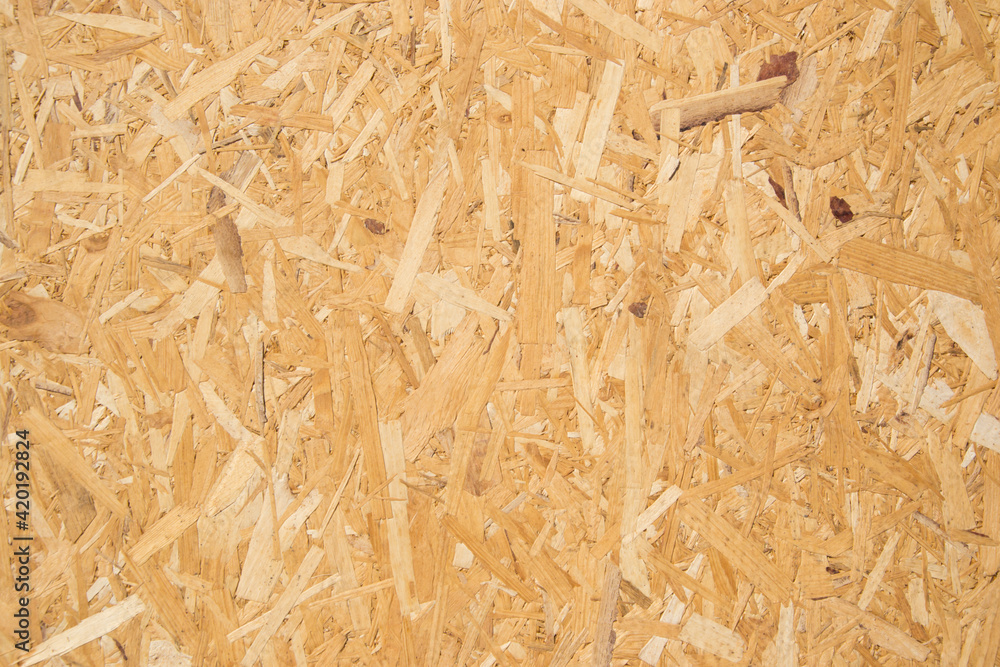 Wooden background, fiberboard or chipboard pattern, pressed wood shavings backdrop, wall made from wood Wooden background, fiberboard or chipboard pattern, pressed wood shavings backdrop, wall made from wood