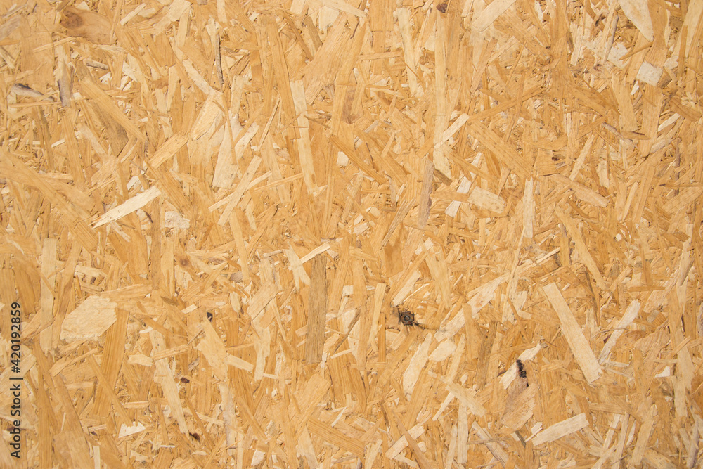 Wooden background, fiberboard or chipboard pattern, pressed wood shavings backdrop, wall made from wood Wooden background, fiberboard or chipboard pattern, pressed wood shavings backdrop, wall made from wood