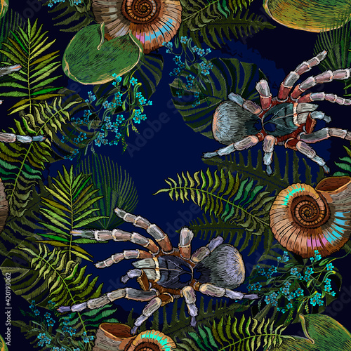 Ammonite fossil, spider tarantula and palm leaves. Ancient tropical gothic forest seamless pattern. Embroidery. Archeology and paleontology background. Template for clothes, print