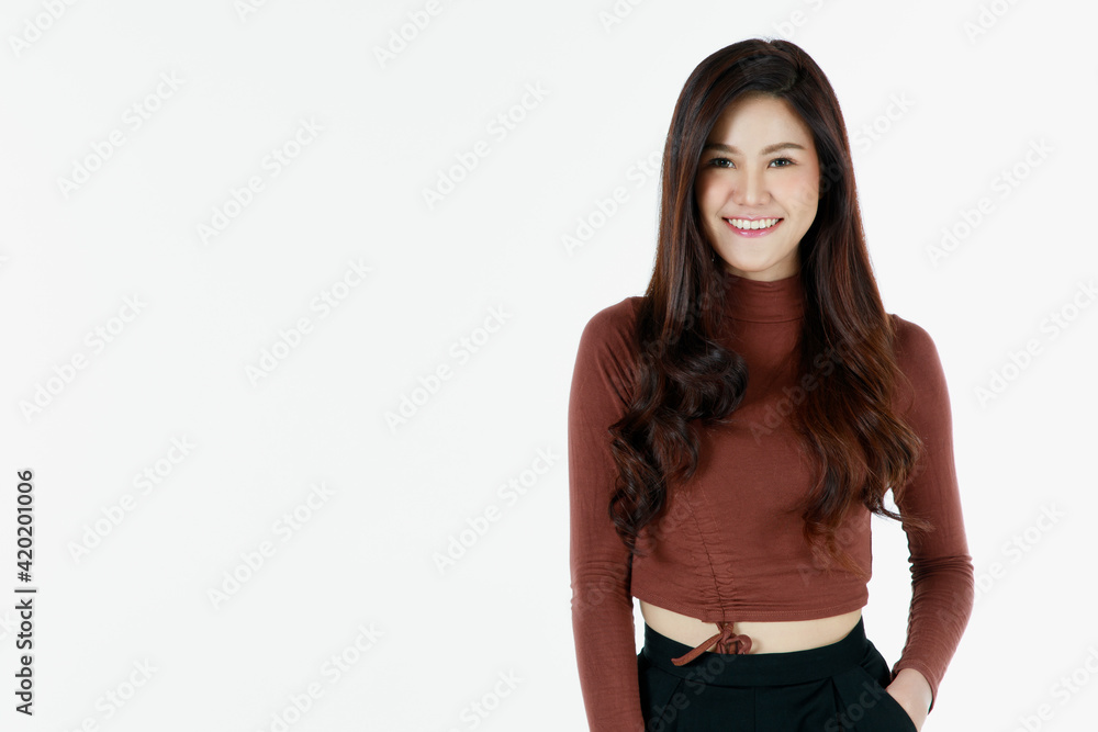 Portrait of young and cute self-confidence brunette long hair Asian girl with smile and friendly face. Charming girl poses with happy studio shot isolated on white background with hand in pocket Portrait of young and cute self-confidence brunette long hair Asian girl with smile and friendly face. Charming girl poses with happy studio shot isolated on white background with hand in pocket