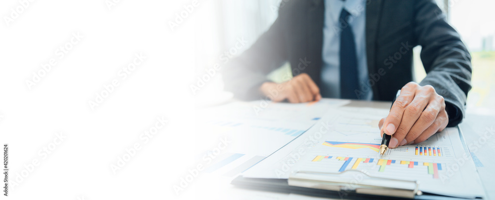 Business people partner negotiating a contract, they are pointing on a document and discussing together,Two businessmen are negotiating in office. Business people partner negotiating a contract, they are pointing on a document and discussing together,Two businessmen are negotiating in office.