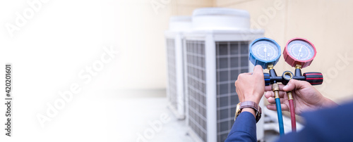 Technician is checking air conditioner ,measuring equipment for filling air conditioners. photo