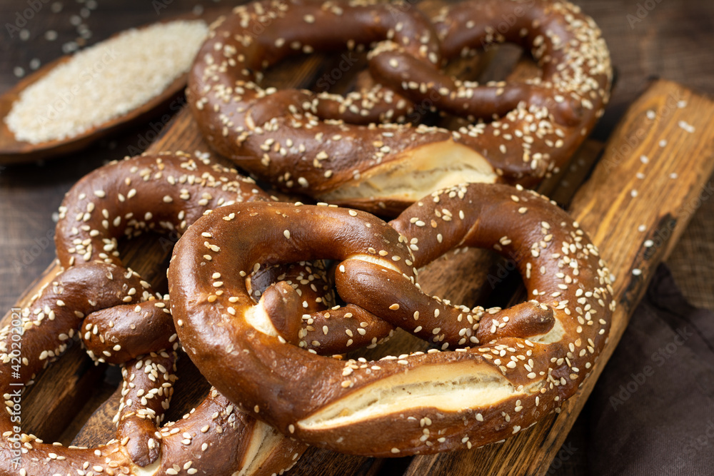 German pretzel. Sesame pretzels on the brown wooden kitchen table