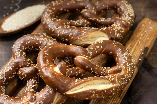 German pretzel. Sesame pretzels on the brown wooden kitchen table