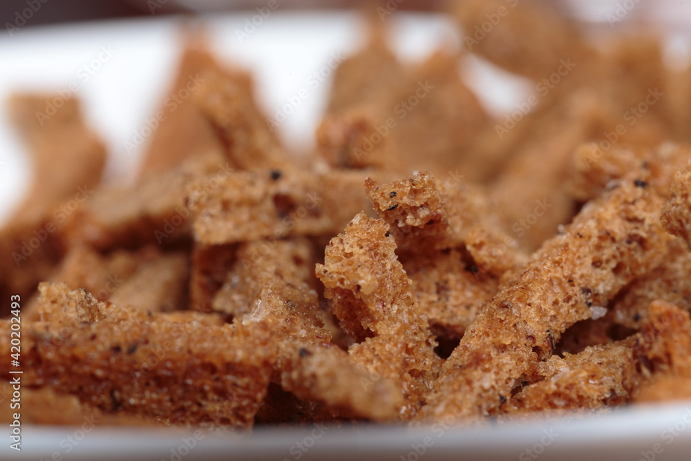 Pile of rye croutons in a white bowl. Pile of rye croutons in a white bowl.