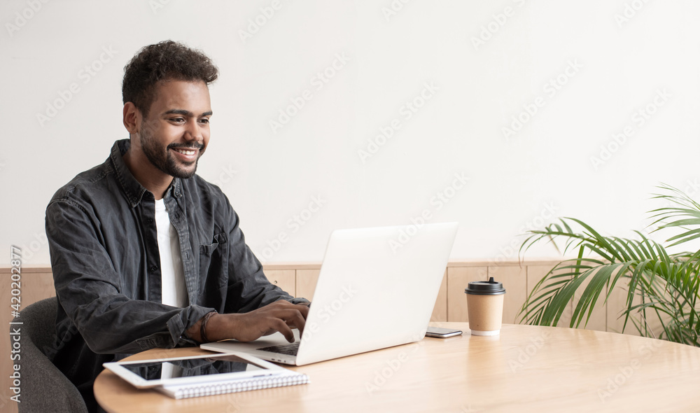 Young handsome man using laptop at home, Businessman or student working online on computer indoors, Freelance, online marketing, distance education, e-learning, home work and lockdown concept Young handsome man using laptop at home, Businessman or student working online on computer indoors, Freelance, online marketing, distance education, e-learning, home work and lockdown concept